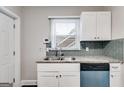 Galley kitchen featuring granite countertops, stainless steel sink, and white cabinets at 1318 Beecher Sw St, Atlanta, GA 30310