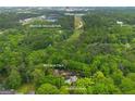 Aerial view of an expansive home and property surrounded by dense trees and nearby Westside Reservoir Park at 68 Edwin Pl, Atlanta, GA 30318