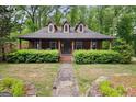 Charming home featuring a cozy front porch, dormer windows, and a well-maintained lawn at 68 Edwin Pl, Atlanta, GA 30318