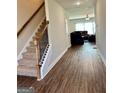 Inviting entryway with stairs, wood floors, and an open view into the living room at 340 Mcgiboney Ln, Covington, GA 30016