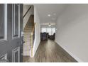 View of the foyer featuring hard surface floors, staircase, and neutral paint at 340 Mcgiboney Ln, Covington, GA 30016