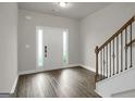 View of the foyer featuring hard surface floors, staircase, and neutral paint at 340 Mcgiboney Ln, Covington, GA 30016