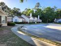Street view showcasing well-maintained townhomes with manicured lawns and lush landscaping at 175 Camry Ln, Grayson, GA 30017