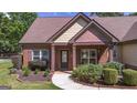 Inviting entryway to home with brick pillars, manicured bushes, and a well-kept lawn at 474 Strawberry Walk, Loganville, GA 30052
