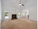 Bright living room with large fireplace and open floor plan, connecting to kitchen area at 474 Strawberry Walk, Loganville, GA 30052