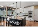 Bright kitchen with a center island, white cabinets, stainless steel appliances, and a cozy breakfast area at 162 Daltree Ct, Marietta, GA 30068