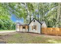 Attractive house with wooden shutters, a covered front porch, and a new wooden fence at 500 Pomona Circle Sw, Atlanta, GA 30315