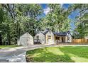 This inviting property features a detached garage, modern fence, and a freshly paved driveway at 500 Pomona Circle Sw, Atlanta, GA 30315