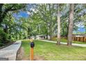 Long paved driveway leads to charming home with large yard and mature trees offering lots of privacy at 500 Pomona Circle Sw, Atlanta, GA 30315