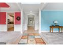 Inviting foyer with colorful accent walls, decorative columns, and view into the kitchen at 1210 Magnolia Park Cir, Cumming, GA 30040