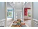 Inviting foyer with colorful accent walls, decorative columns, and view to front door at 1210 Magnolia Park Cir, Cumming, GA 30040