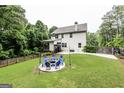 Spacious backyard features a patio with outdoor seating, a well-maintained lawn, and a classic wood fence at 101 High Bluff Trl, Carrollton, GA 30116