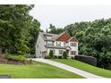 Charming home with a long driveway surrounded by mature trees, and a manicured front lawn at 101 High Bluff Trl, Carrollton, GA 30116