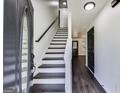 Bright entryway with a staircase, fresh paint, and wood-look flooring, creating a welcoming first impression at 131 Turning Point, Stockbridge, GA 30281