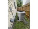 HVAC unit beside the house, placed beside a wooden fence for effective cooling at 2208 Crossrail Dr, Atlanta, GA 30349