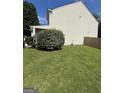 The house has a large, well-kept lawn along the side, complemented by green shrubs at 2208 Crossrail Dr, Atlanta, GA 30349