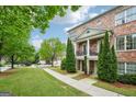 Charming brick townhome with a balcony, set on a well-maintained lawn with lush greenery at 1858 Preserve Way, Atlanta, GA 30341