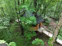 Unique treehouse exterior featuring a wooden walkway through lush greenery at 6290 Cascade Palmetto Hwy, Fairburn, GA 30213