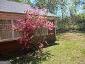 View of a pink azalea bush against the brick wall of the home at 920 Courthouse Rd, Temple, GA 30179