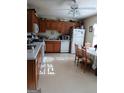 Bright kitchen with wooden cabinets, white appliances, and adjacent dining area at 920 Courthouse Rd, Temple, GA 30179