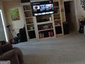 Spacious living room with built-in shelves and a large screen TV at 920 Courthouse Rd, Temple, GA 30179
