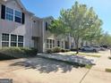 Charming townhomes featuring well-manicured lawns, trees, and inviting curb appeal at 2268 Nicole Dr, Hampton, GA 30228