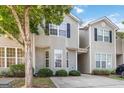 Charming exterior view of the townhome showcasing its siding, windows, and manicured landscaping at 2268 Nicole Dr, Hampton, GA 30228