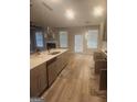 Open concept kitchen featuring stainless steel appliances, a large island, and wood floors at 1049 Homer Ln, Stockbridge, GA 30281