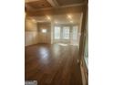 Bright and airy living room featuring hardwood floors, decorative molding, and large windows at 1049 Homer Ln, Stockbridge, GA 30281