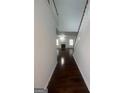A hallway with wood floors, a staircase and white railings and trim at 921 Winding Down, Grayson, GA 30017
