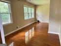 Spacious living room with hardwood flooring, neutral walls, and large windows offering natural light at 503 Roy Huie Rd, Riverdale, GA 30274