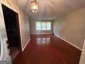 Bright living room with hardwood floors and abundant natural light from large windows at 503 Roy Huie Rd, Riverdale, GA 30274
