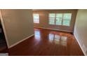 Spacious living room featuring gleaming hardwood floors and large windows at 503 Roy Huie Rd, Riverdale, GA 30274