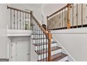 Classic staircase with wooden steps and decorative metal railing at 4733 Julian Way, Acworth, GA 30101