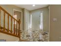 Bright foyer features decorative tile flooring, closet, and a wood staircase at 2436 Green Hollow Ct, Conyers, GA 30012