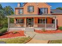 Inviting front porch with gray wood railing and a walkway with red mulch landscaping at 2436 Green Hollow Ct, Conyers, GA 30012
