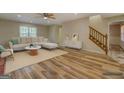 Bright, staged living room boasts hardwood floors, neutral walls, and a modern design at 2436 Green Hollow Ct, Conyers, GA 30012