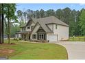 Side view of a lovely home featuring a two-car garage and a well-maintained yard at 337 Paynes Lake Rd, Carrollton, GA 30116