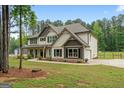 Side view of the home showcasing the garage, spacious yard, and attractive design at 337 Paynes Lake Rd, Carrollton, GA 30116