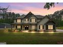 Beautifully illuminated home at dusk, accentuating its elegant architecture and curb appeal at 337 Paynes Lake Rd, Carrollton, GA 30116