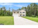 Inviting two-story home with an attached two-car garage, and concrete driveway at 210 Jenny Ct, Grantville, GA 30220