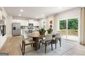 Bright kitchen featuring stainless steel appliances and an adjacent dining area with deck access at 7223 Lacey Dr # 146, Douglasville, GA 30134