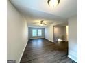 Open-concept living room featuring vinyl floors, natural light, and neutral paint at 3170 W Point Cir, Douglasville, GA 30135