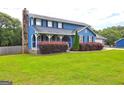 Charming two-story home with a stone chimney and a spacious front yard at 108 Country Acres Ct, Mcdonough, GA 30253