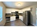 Modern kitchen with stainless steel appliances, granite countertops, and decorative backsplash at 4039 Codel Nw St, Atlanta, GA 30331
