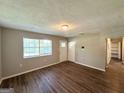 Inviting living room with wood-look floors, neutral walls and natural light from a window at 4039 Codel Nw St, Atlanta, GA 30331