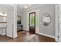 Elegant foyer with dark wood floors, stylish mirror, and a view to the covered front porch at 1104 Victoria Ne St, Atlanta, GA 30319