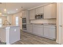 Spacious kitchen featuring stainless steel appliances, gray cabinets and an island at 132 Post Oak Dr St, Jackson, GA 30253