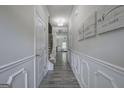 Elegant hallway with decorative wainscoting, hardwood floors, and recessed lighting at 158 Bryon Ln, Acworth, GA 30102