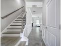 Bright hallway with hardwood floors, wainscoting, and a staircase leading to the upper level at 158 Bryon Ln, Acworth, GA 30102